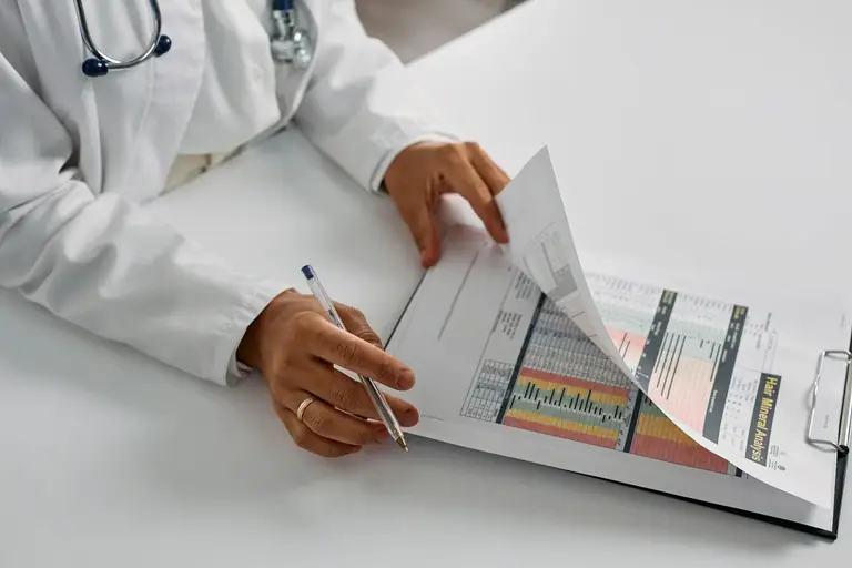 A clinician reviewing a blood test report